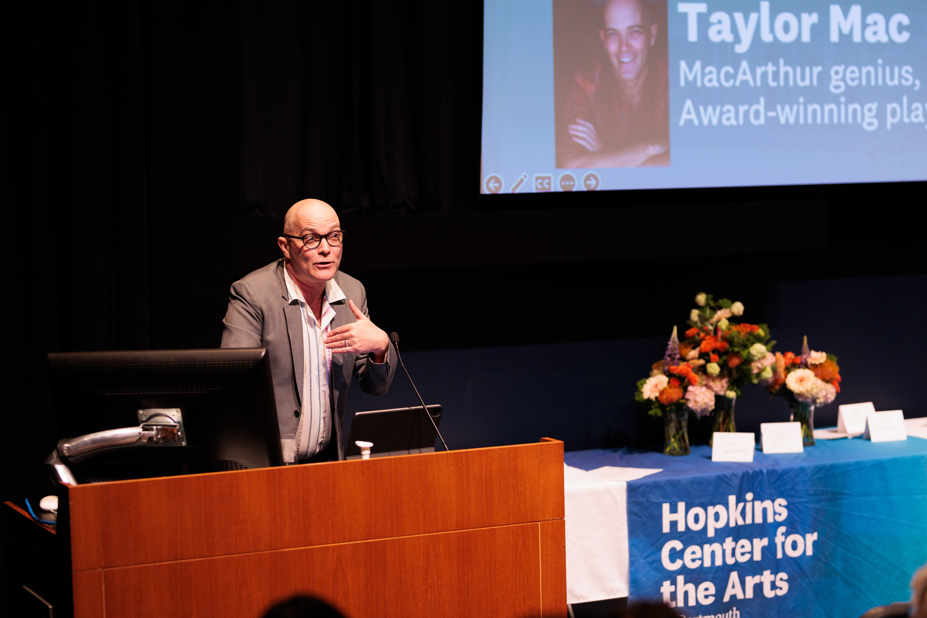 Taylor Mac speaking at a podium